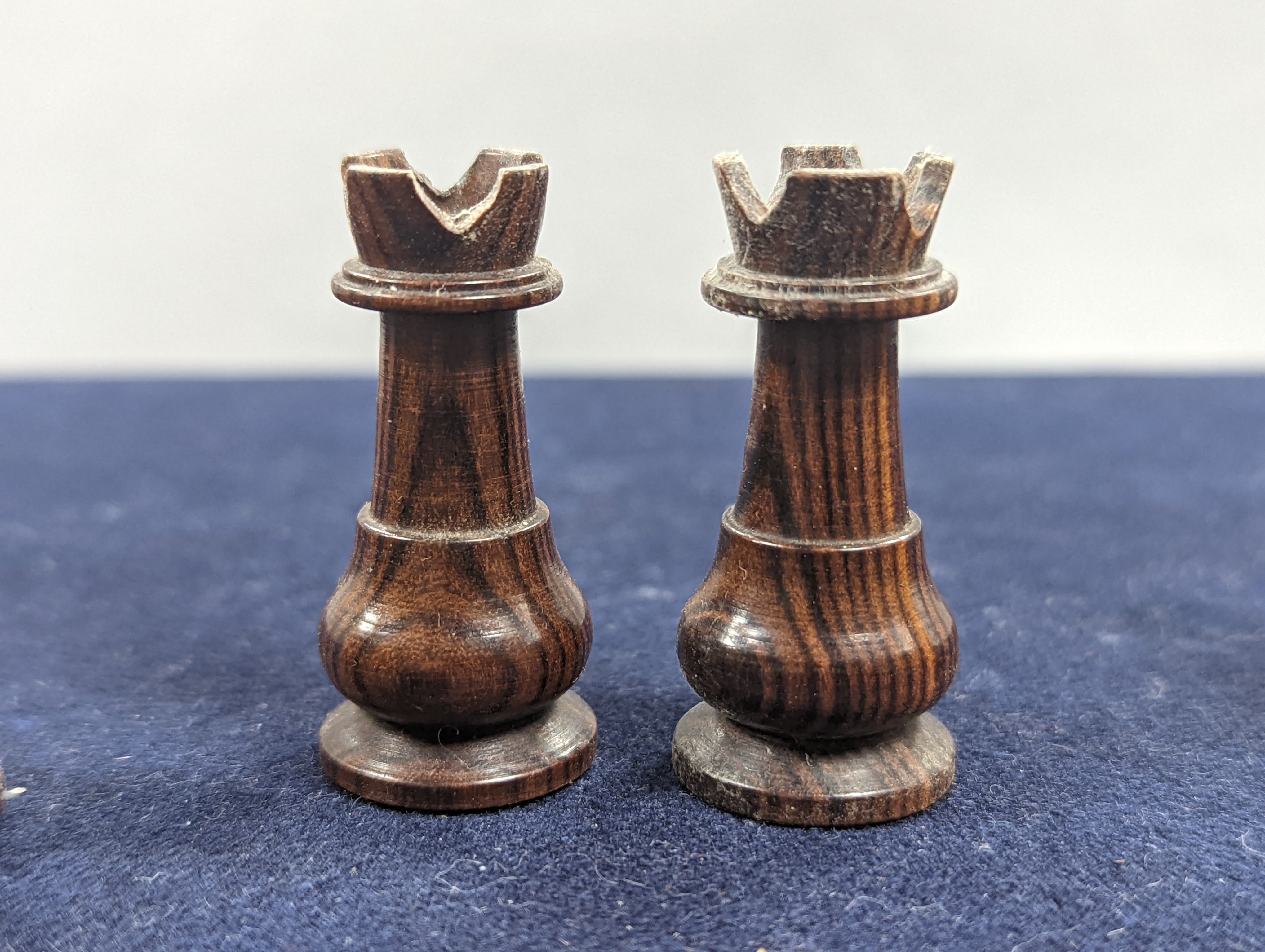 A Victorian brass inset mahogany games box, fitted with solitaire, cribbage, chessmen, draughts etc., 33cm, a turned and stained bone chess set, another games box containing chessmen and draughts